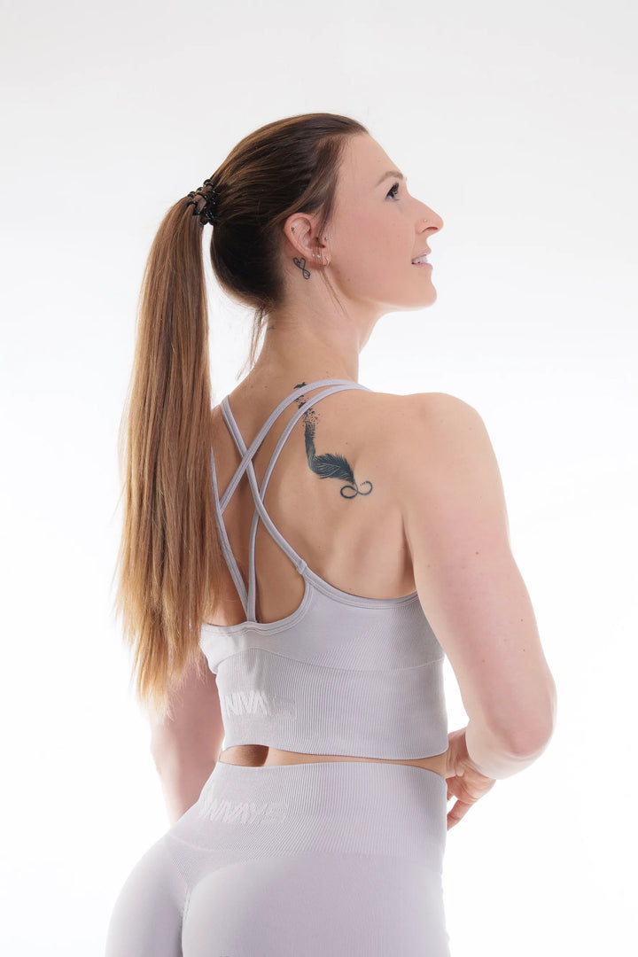 NIVɅYS sports bra featuring supportive design and sustainable recycled performance fabric.