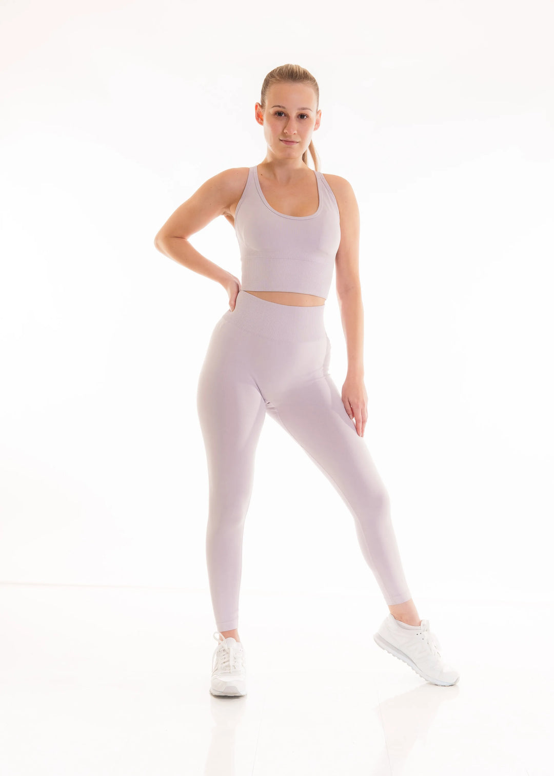 Women in NIVɅYS performance wear, modern fit of sustainable recycled activewear.