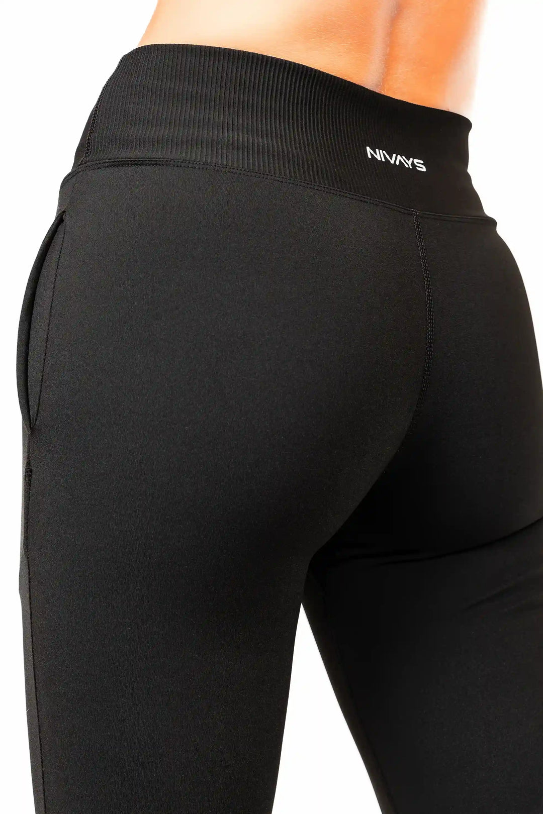 Woman wearing NIVɅYS eco-conscious sportswear for training and performance.